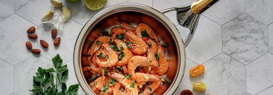 Frying pan on an induction cooktop with a small magnet showing induction compatibility