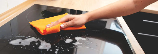 Induction-compatible oven-safe cookware on a modern kitchen cooktop in a bright NZ-style home kitchen