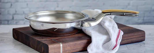 Induction-ready stainless steel pans on a modern induction cooktop in a bright NZ kitchen