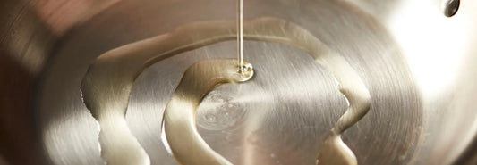 Premium stainless steel pots and pans displayed on a modern kitchen bench