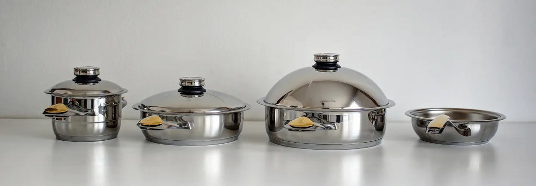 Zepter 24 cm and 30 cm stainless steel woks compared on a flat kitchen cooktop