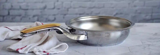 Stainless steel frying pan on an induction hob for a guide to PFAS-free cookware in NZ
