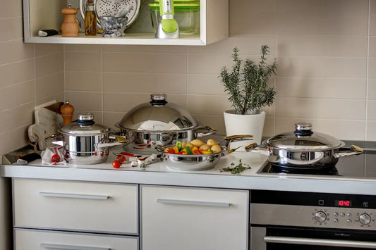 Stainless steel pan on an induction cooktop with a magnet test showing induction-compatible cookware.