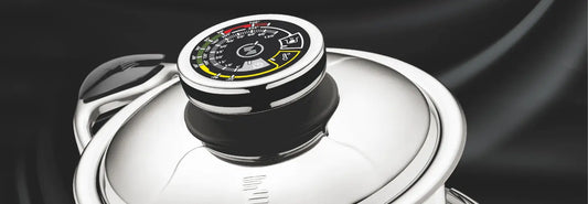 Stainless steel saucepan and sauté pan on an induction cooktop in a bright kitchen